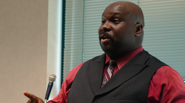 Indianapolis homicide detective Harry C. Dunn talks at a 2018 public hearing about the charter school he wants to open. - Eric Weddle/WFYI News
