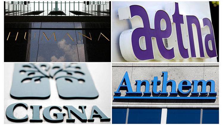 This photo combo shows signage for health insurers Humana Inc., Aetna Inc., Cigna Corp., and Anthem Inc. - AP photo