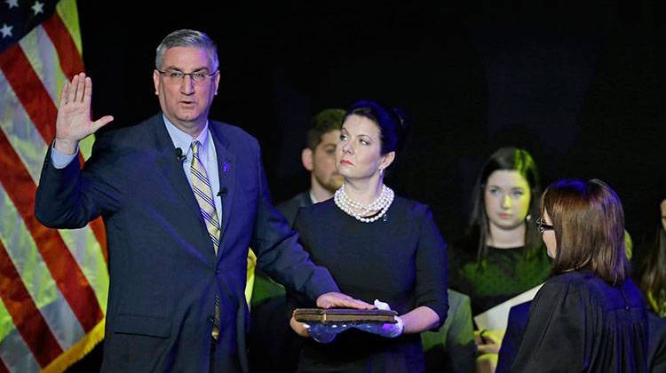 Eric Holcomb is sworn in as Indiana's governor by Chief Justice Loretta H. Rush on a bible held by his wife Janet during an inaugural ceremony in Indianapolis, Monday, Jan. 9, 2017. -  AP Photo/Michael Conroy