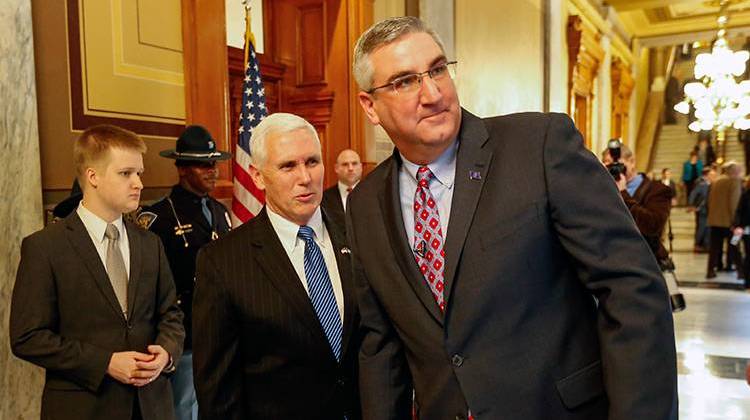Lt. Gov. Eric Holcomb, right, is looks at the crowd with Gov. Mike Pence after Holcomb was sworn in as Lt. Governer at the Statehouse in Indianapolis, Thursday, March 3, 2016. Holcomb was chosen by Gov. Mike Pence to replace Sue Ellspermann. - AP Photo/AJ Mast