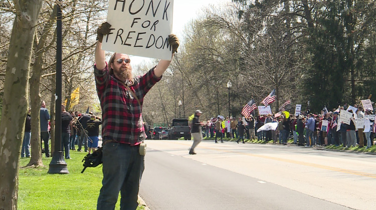 Hundreds of demonstrators gathered at the governor's mansion waiving flags and signs to protest the state's "Stay-At-Home" order.  - Lauren Chapman/IPB News