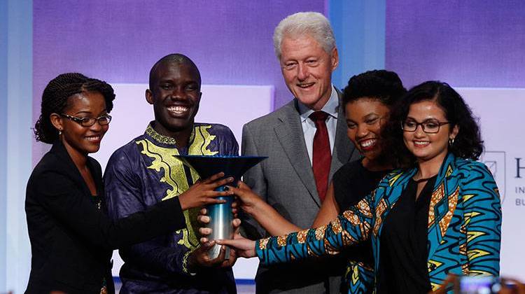 Former President Bill Clinton (center) stands with winners, Leslie Ossete, Wyclife Omondi, Iman Cooper and Sonia Kabra of Team Magic Bus, from Earlham College, during the Hult Prize Finals and Awards Dinner at the Clinton Global Initiative Annual Meeting on Tuesday, Sept. 20, 2016, in New York. - Jason DeCrow/AP Images for Hult Prize Foundation
