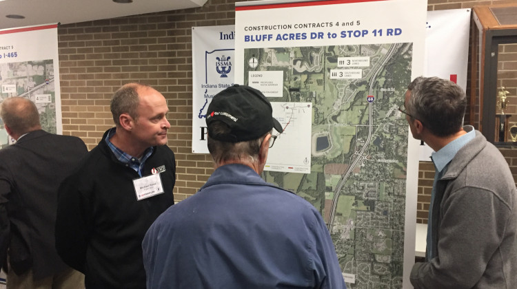 Local residents examine a map explaining changes part of the I-69 Section 6 project. - Erica Irish/WFYI
