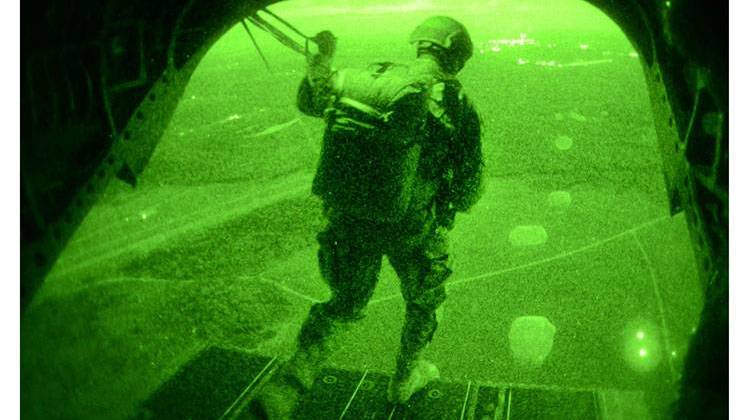 A Special Forces Soldier with the Illinois National Guardâ€™s Company A, 2nd Battalion, 20th Special Forces Group (Airborne) in Chicago, conducts a night static line jump from a CH-47D Chinook with Company B, 2nd Battalion, 238th Aviation Regiment in Peoria, Illinois, at Fort McCoy, Wisconsin. - U.S. Army / Sgt. 1st Class Kassidy Snyder