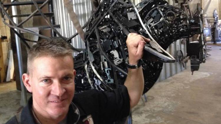 Firefighter and metal artist Ryan Feeney, with the Peace Dove, in his studio.