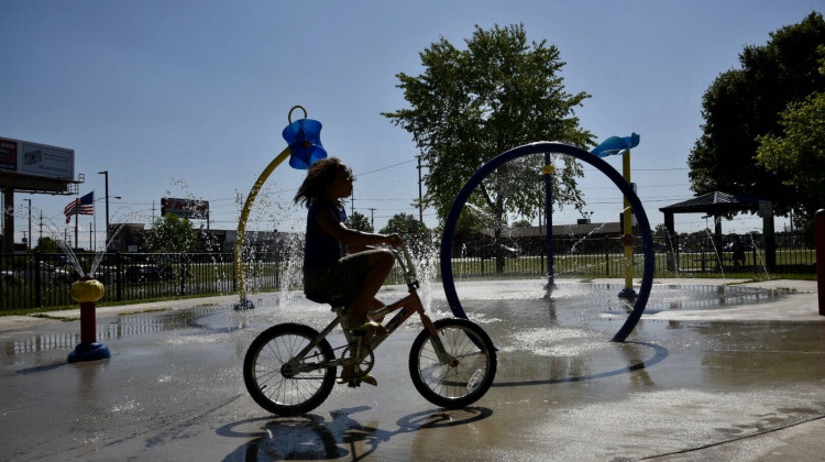 A young child rides a bike at a splash pad in South Bend. - Justin Hicks