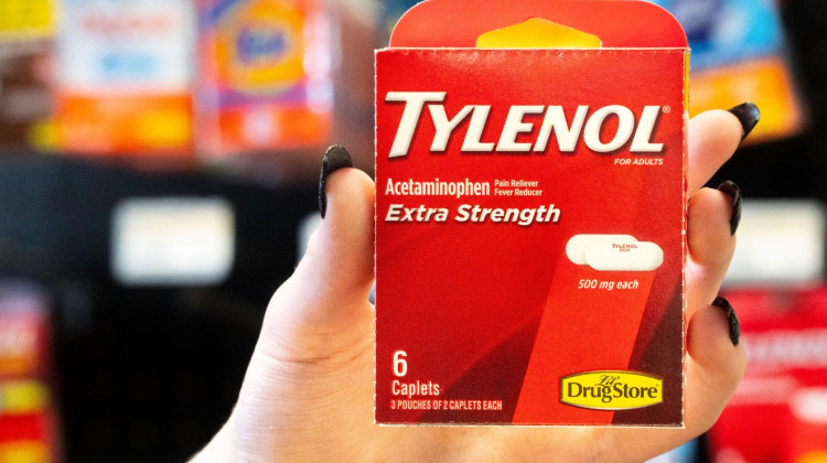 An Evansville Bargetown Market employee holds a package of Tylenol, sold behind the counter. - Tim Jagielo / WNIN News