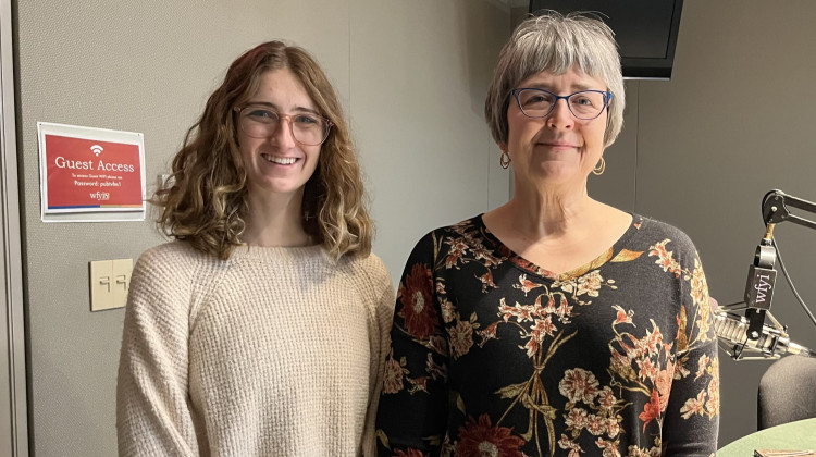 Aubrey Miles, an intern at the Benjamin Harrison Presidential Site and Jennifer Capps, VP of exhibition and curatorship, share some of the new artifacts on exhibit. (Jill Sheridan WFYI)