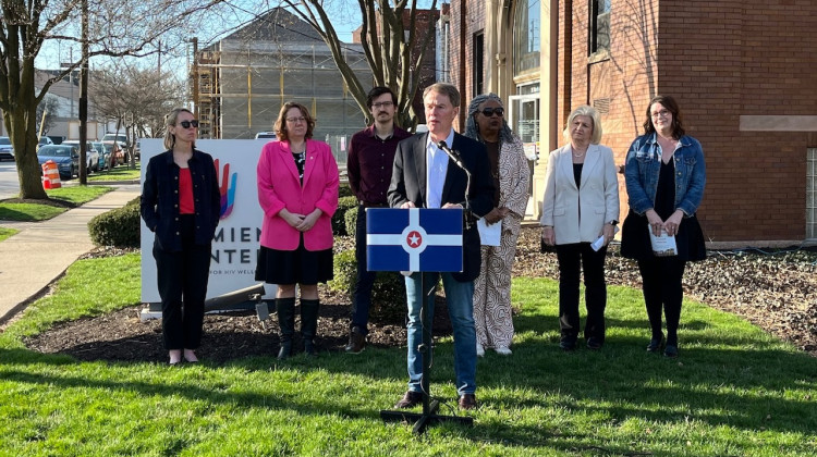 Mayor Joe Hogsett stands in front of the Damien Center as he announces historic federal investments in Indianapolis’ homelessness programs. - WFYI News / Ben Thorp