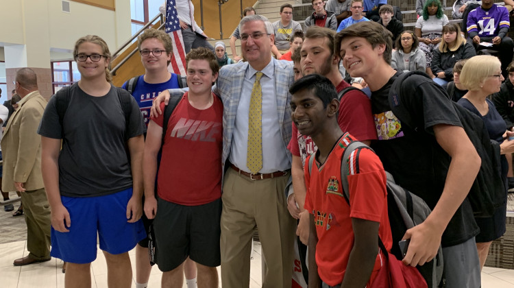 Gov. Eric Holcomb poses with teens at Fishers High School. - Jill Sheridan/IPB News