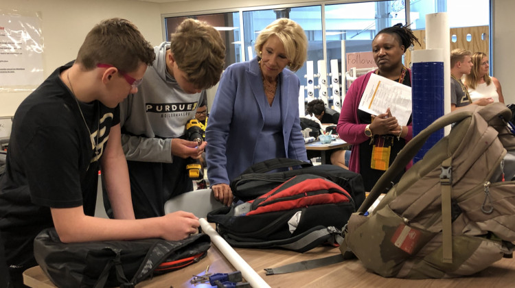 Students show U.S. Secretary of Education Betsy DeVos a project they have been working on. - Darian Benson/WFYI
