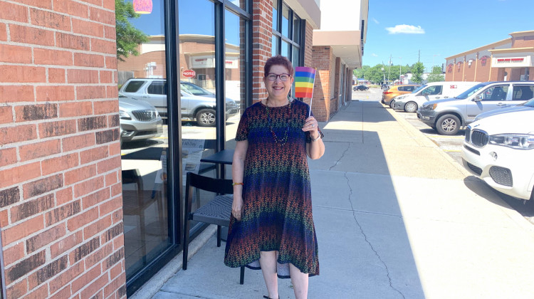 Annette Siegel Gross waves her flag with pride on the Northside of Indianapolis - Grace Callahan/WFYI