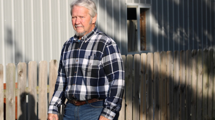 Brian Daggy stands at the fence along his property in Boone County  - (WBAA News/Ben Thorp)