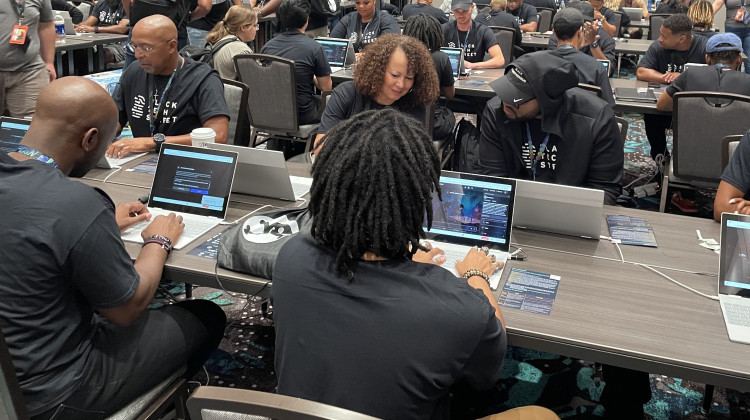 Marvin Jones (left) and Rose Washington-Jones (center), from Tulsa, Okla., took part in the AI red-teaming challenge at Def Con earlier this month with Black Tech Street. - Deepa Shivaram / NPR