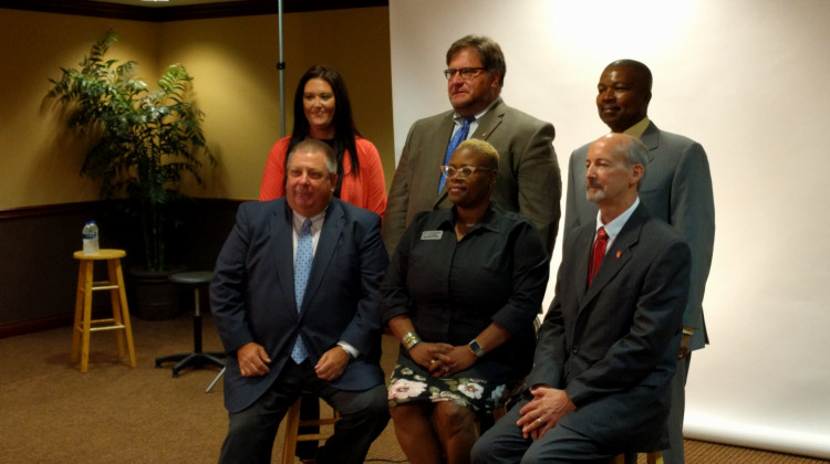 The new members of the Muncie Community Schools board pose for a photo; First row: Dave Heeter, WaTasha Barnes Griffin, James Lowe.  Second row: Brittany Bales, James Williams, Keith O'Neal. (Stephanie Wiechmann/Indiana Public Radio)