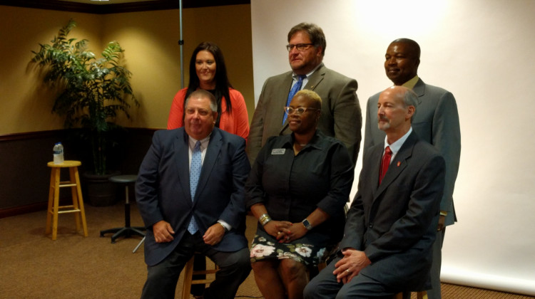 The new members of the Muncie Community Schools board pose for a photo; First row: Dave Heeter, WaTasha Barnes Griffin, James Lowe. Second row: Brittany Bales, James Williams, Keith O'Neal. (Stephanie Wiechmann/Indiana Public Radio)