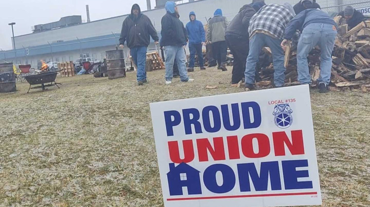 Workers striking outside the MonoSol plant in LaPorte pile up wood to keep firepits going as they prepare for another week on strike. - Adam Yahya Rayes/IPB News