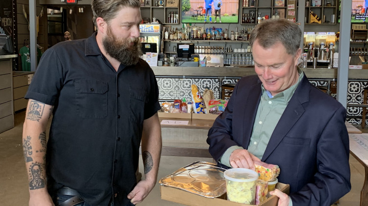 Mayor Joe Hogsett picks up dinner at Half Liter. (Jill Sheridan WFYI)