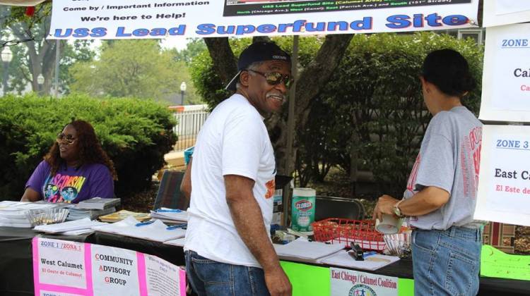 Ray Mosley works at the Community Advisory Group table with Akeeshea Daniels, left, and Maritza Lopez at Calumet Day, an annual block party. The CAG represents residents of the EPA-administered USS Lead Superfund site in East Chicago. - Annie Ropeik/IPB News