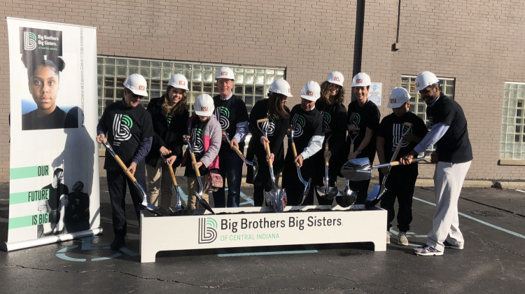 The BBBSCI team along with Mayor Joe Hogsett break ceremonial ground on the new mentor hub located on Meridian Street in downtown Indianapolis. - Carter Barrett/WFYI