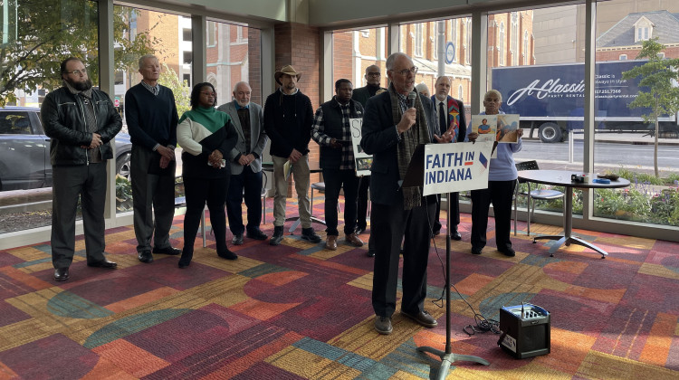 Members of Faith in Indiana and advocates speak at a press conference at the Indiana Convention Center on Oct. 20, 2022. - Katrina Pross/WFYI