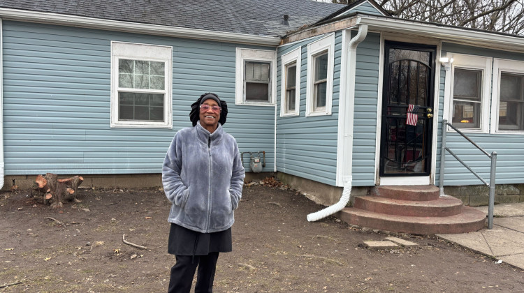 Peggy Bills, 77, stands in front of her newly repaired home in the Martindale-Brightwood neighborhood. She has lived there for nearly 60 years. - Abriana Herron / WFYI