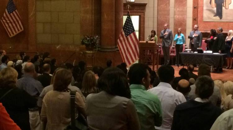 Local dignitaries, 96 immigrants, and their families pledged allegiance to the American flag. - Photo By: Deron Molen