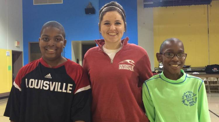 Mario (L) stands with UIndy Mentor Gabby Ingram (C) and younger brother Michel (R) following a quick pickup game of basketball. - Photo By: Deron Molen