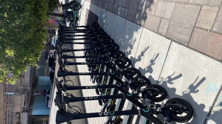 A line of Public E-Scooters on the 500 block of South Harrison St. near the Landing in downtown Fort Wayne - Rebecca Green / 89.1 WBOI