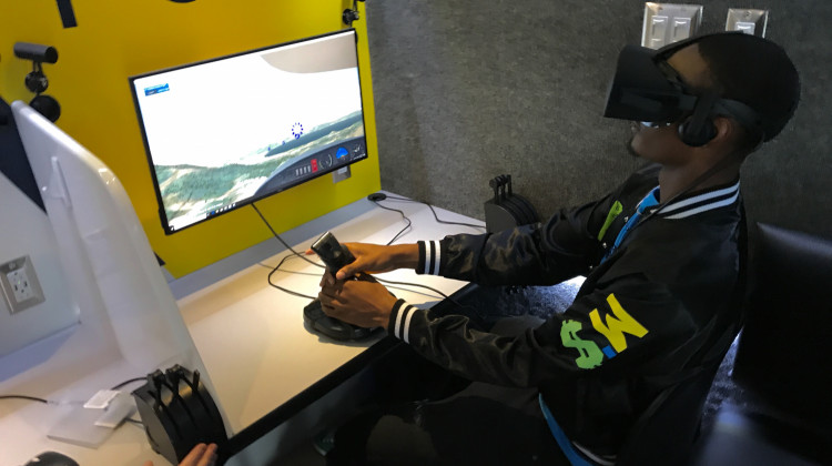 A high school student tries LIFT Academy's flight simulator at a career fair in Indianapolis. - Justin Hicks/IPB News