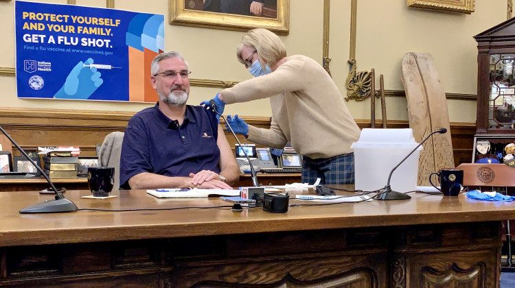 State Health Commissioner Dr. Kris Box gives a flu shot to Gov. Eric Holcomb. -  Brandon Smith/IPB News