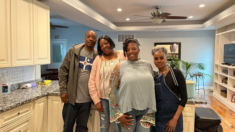 Regina Allen (second from left) with some of her family and staff at the home in Fall Creek Place. - Jill Sheridan WFYI