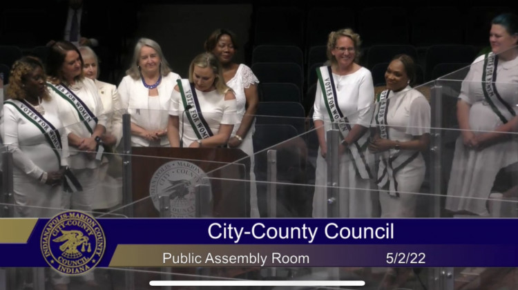 Female councilors past and present offer a special resolution. (Jill Sheridan WFYI)