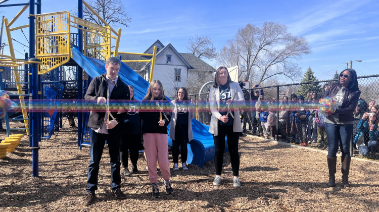 Hannah's father Jeremy, sister Charlotte and mother Cassandra Crutchfield, alongside IPS Superintendent Aleesia Johnson, at a ribbon cutting for Hannah's Memorial Playground. - Lee Gaines/WFYI News