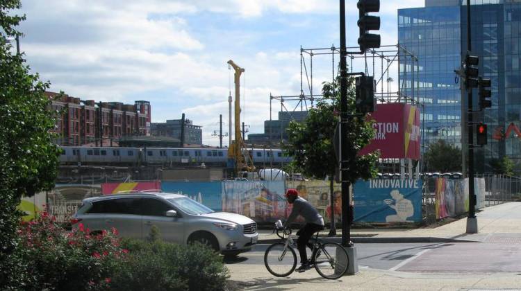 A cyclist rides on the sidewalk in the NoMa neighborhood of Washington, D.C.