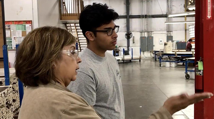 Chris Camacho, a youth apprentice in a similar program in Elkhart County, learns about the operations of the factory on his first day.  - Justin Hicks/IPB News