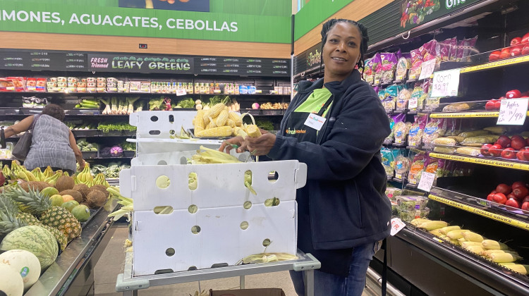 Community member Tonya Hoskins works in the produce department. She's excited to have a grocery store close to home to serve her family. - Elizabeth Gabriel/WFYI