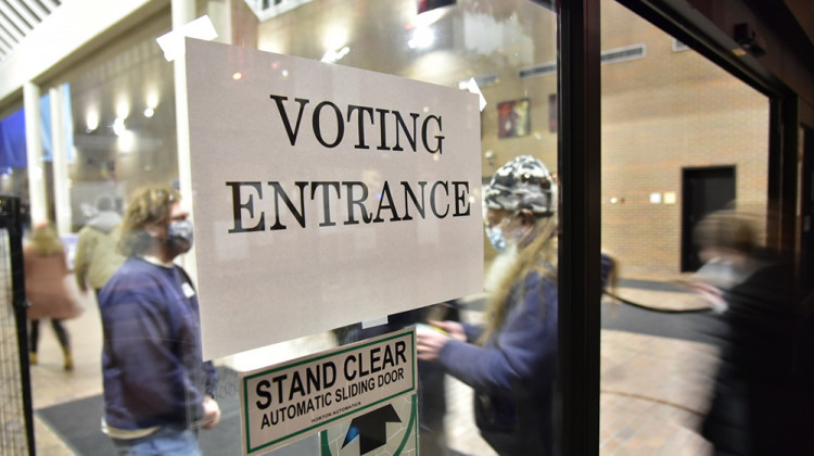 Voters show their identification to workers as they enter the Century Center, a polling site in South Bend, in the first hour of Election Day.  - Justin Hicks / IPB News