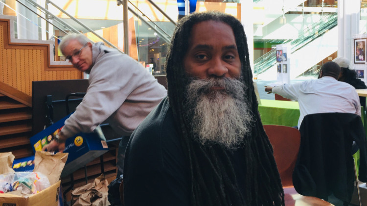 Maurice Young hands out lunches at an Indianapolis library. He also helps people navigate health insurance. - Jill Sheridan/IPB News