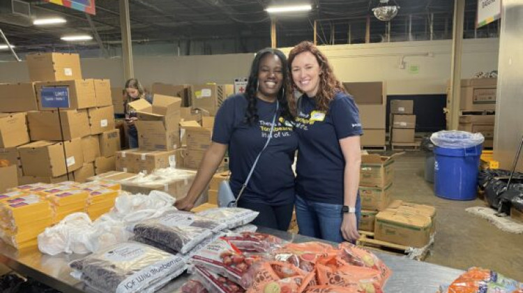 Dawnita Anderson (left) and Stephanie Buchner (right) from Liberty Mutual volunteer their time at the food bank. - Photos/Chloe McGowan