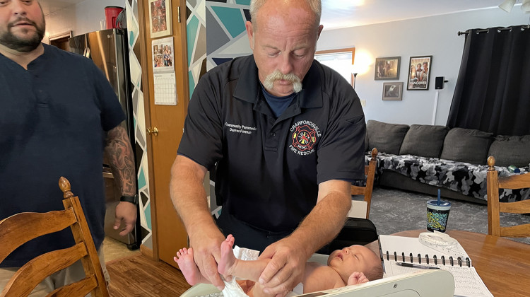 Project Swaddle paramedic Darren Forman sets five-week-old Wilder on a scale to monitor his growth. - (Carter Barrett/Side Effects)