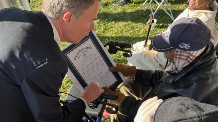 Indianapolis Mayor Hogsett presents Albert Arnold, whom the new homes are named after, with a proclamation. - WFYI News/Jill Sheridan