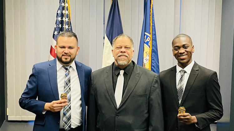 Keegan Allen (right) and Jose Rivas (left) were sworn in as Indianapolis Metropolitan Police Department chaplains on Jan. 26, 2023. The two stood with IMPD Chief Randal Taylor (middle) for a photo with their badges. - Courtesy of IMPD News