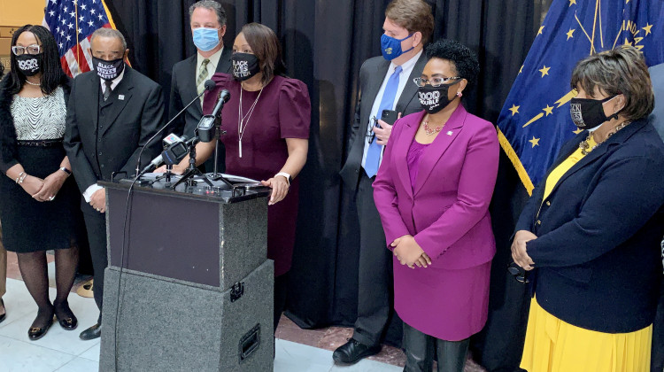 Indiana Black Legislative Caucus Chair Robin Shackleford (D-Indianapolis), center, is flanked by House Speaker Todd Huston (R-Fishers), left, and House Democratic Leader Phil GiaQuinta (D-Fort Wayne), right. - Brandon Smith/IPB News