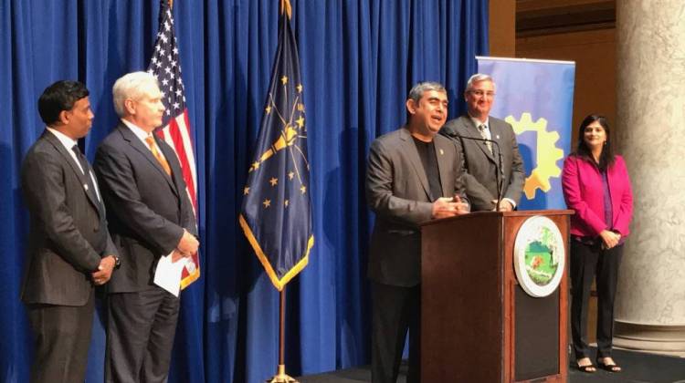 Infosys CEO Vishal Sikka, center, talks about his company's decision to locate in Indiana. He's flanked by state officials and leaders from his company. - Brandon Smith/IPB