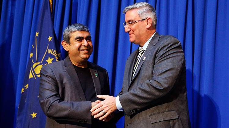 Indiana Gov. Eric J. Holcomb, right, greets Dr. Vishal Sikka, CEO of Infosys, following an announcement at the Statehouse in Indianapolis, Tuesday, May 2, 2017. - AP Photo/Michael Conroy
