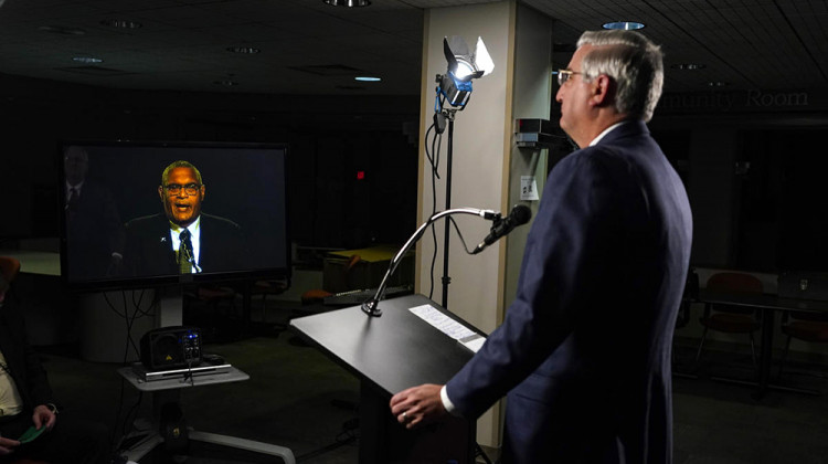 Due to COVID-19 precautions, the three gubernatorial candidates and the moderator were in separate rooms at WFYI studios in Indianapolis. Here, Republican Gov. Eric Holcomb watches Democrat Dr. Woody Myers speak. - Darron Cummings/Associated Press