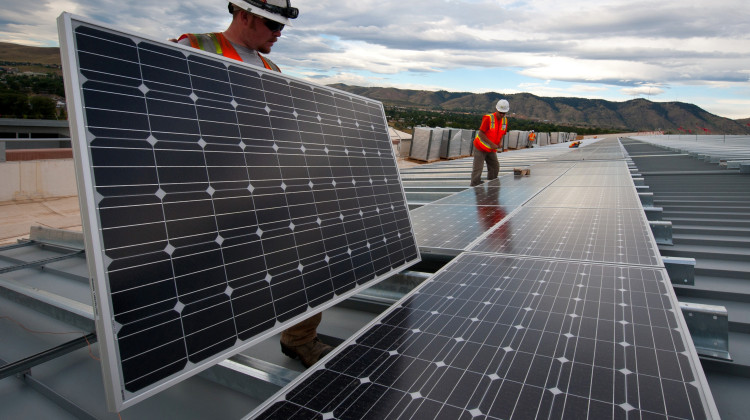 Brian Lawson and Kenesaw Burwell work on panels that the Energy Department is using to leverage a Power Purchase Agreement with Sun Edison and Xcel Energy in 2012. - Dennis Schroeder/Wikimedia Commons