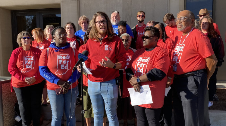Members of the Indianapolis Education Association stand outside the Indianapolis Public Schools main office in September to raise concerns about a district proposal to close schools.  - Elizabeth Gabriel/WFYI News