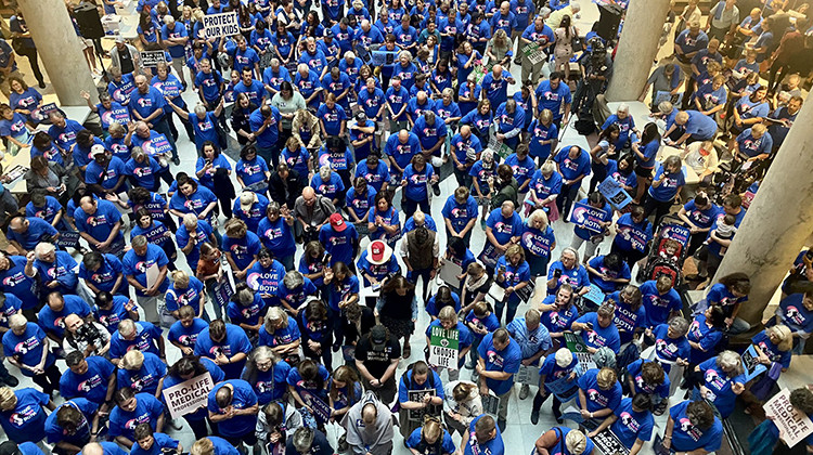 Indiana Right to Life rally attendees bow their heads in prayer inside the Statehouse on July 26, 2022. - Emilie Syberg/WFYI